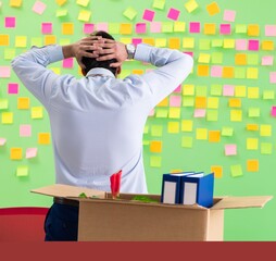 Man collecting his stuff after redundancy in the office with man