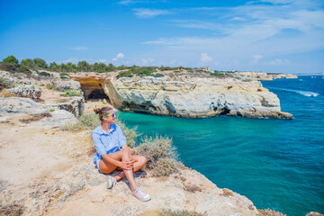 Girl looking out on the ocean. Lagos, Algarve Coast, Portugal