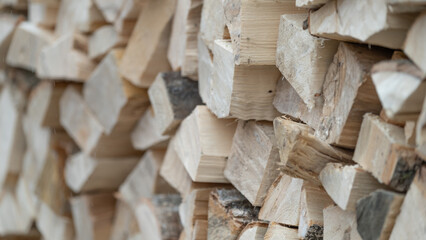 Dry chopped firewood logs ready for winter. Wooden sheds for storing firewood in the yard. High quality photo
