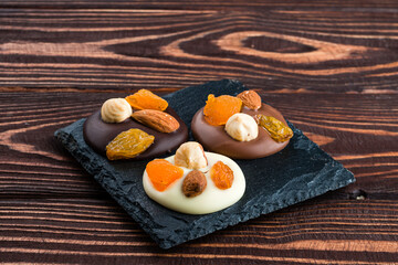 chocolate dessert with nuts, almonds, dried apricots and raisins