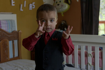 portrait of elegant little boy gesturing