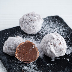 round candy made of milk chocolate in powdered sugar