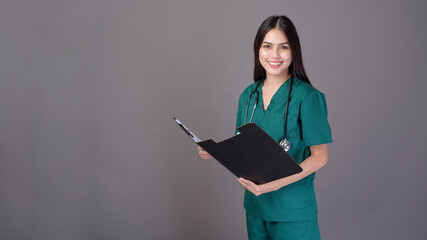 young happy beautiful woman doctor wearing a green scrubs is holding documents