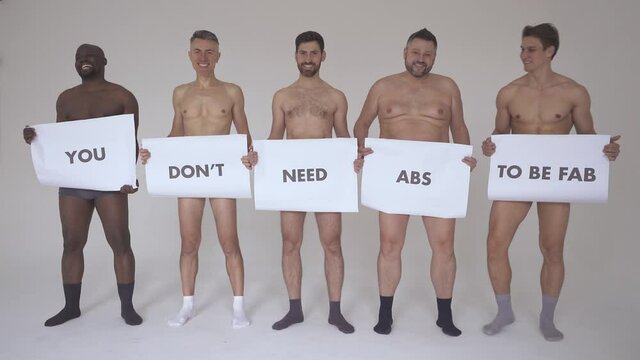 group of multiethnic men posing for a male edition body positive beauty set. Shirtless guys with different age, and body wearing boxers underwear