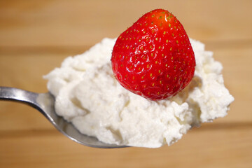 milk cream with berry strawberry sauce in white plate, healthy breakfast concept