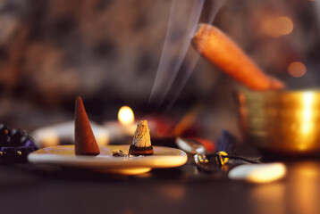 Fototapeta na wymiar Burning aromatic incense smoky stick for meditation and relaxingon on abstract background