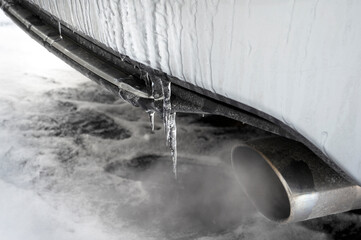 frozen car covered with ice in cold winter day, back view