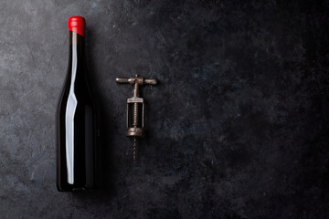 Red wine bottle and vintage corkscrew