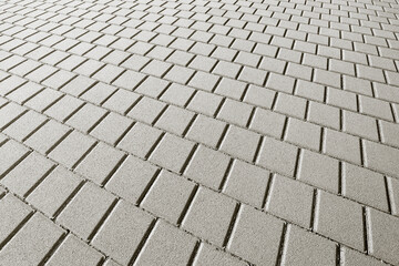 Gray concrete flooring block assembled on a substrate of sand - type of flooring permeable to rain water as required by the building laws