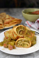  Thin German Pancakes (like French crepes) with sweet caramelized rhubarb filling, served with loads of cinnamon and sugar. The pancake is the classic from the kitchen of our childhood.