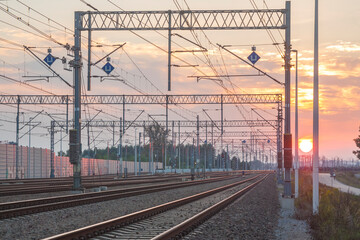 Fototapeta na wymiar Railroad Tracks and Overhead Lines at Sunset