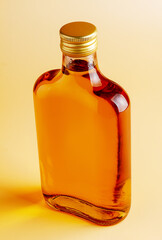 A bottle of brandy on a uniform background