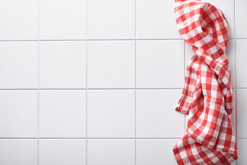 Red napkin on white stone tile table. Food cooking background and mock up.