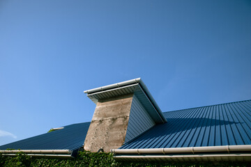 Blue roof of the house against the sky