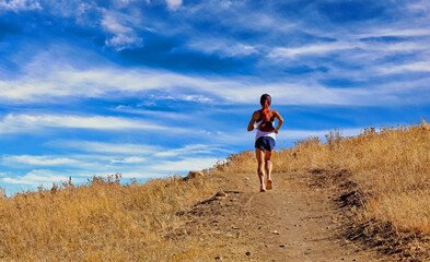 Naklejka premium Woman jogging on a Colorado hiking/biking trail