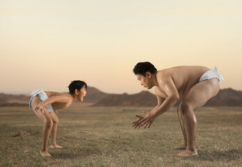 Two sumo wrestlers. Big and little - obrazy, fototapety, plakaty
