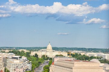 Pennsylvania Street and major monumental buildings including US Capitol in a cloudy day -...
