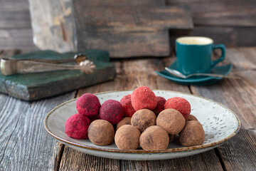 Energy balls. Raw healthy sugar free dessert made from dates, walnuts, cocoa powder, strawberry and beetroot powder. Handmade sweets. Proper nutrition.