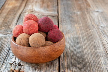 Energy balls. Raw healthy sugar free dessert made from dates, walnuts, cocoa powder, strawberry and beetroot powder. Handmade sweets. Proper nutrition.