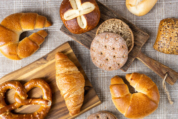 Various types of bread, buttery croissants, breads, rolls, baguettes, Fresh baked goods, flat lay
