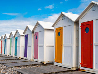 Row of traditional bathing huts with pastel colored doors at Le Treport beach, Normandy, France
