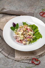 Nutritious salad with ham, tomatoes, cucumber and croutons.