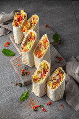 A delicious doner donair kebab wrap with meat, lettuce, tomato,  onion and sauce.