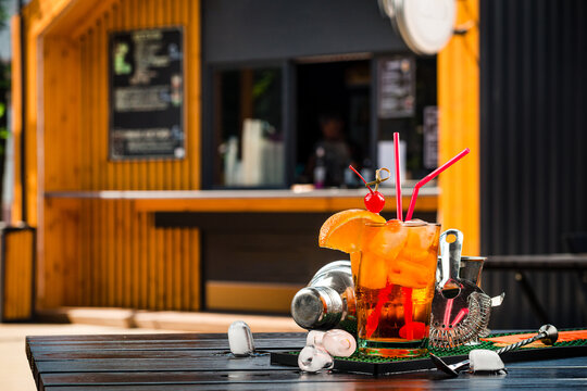 cocktail with a slice of orange and cherry