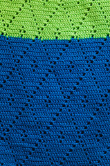 Knitted blue green texture. Crocheted geometric pattern.
