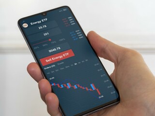 Stock exchange etf energies market chart, Stock market data on smartphone. Business analysis of an energy ETF
