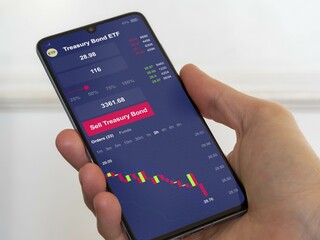 Stock exchange market chart, t-bonds, t bond etf market data on smartphone. Business analysis of an treasury bond ETF