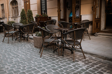 Empty tables of outdoor cafe in old city center of Lviv, Ukraine in Europe