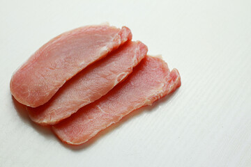 Sliced raw pork meat on light background