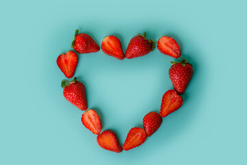 Flat lay frame in the shape of a heart made from ripe strawberries. Love concept. Valentine's day concept
