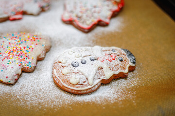Christmas cookies sprinkled with icing sugar on a baking sheet.