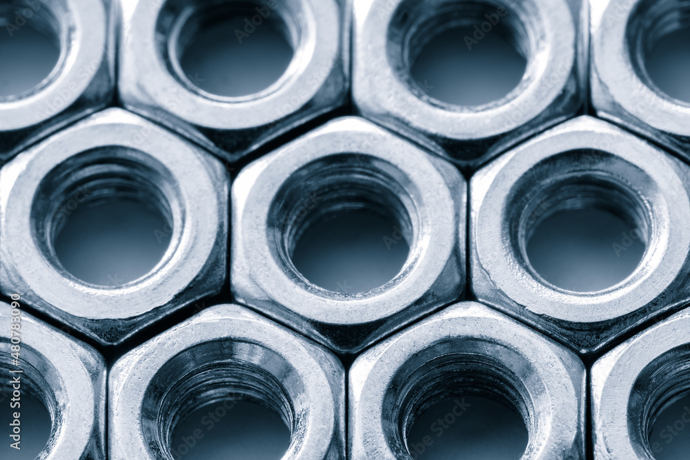 Aufkleber Metal nuts in a row background. Chromed screw nuts. Steel nuts pattern. Tools for work.