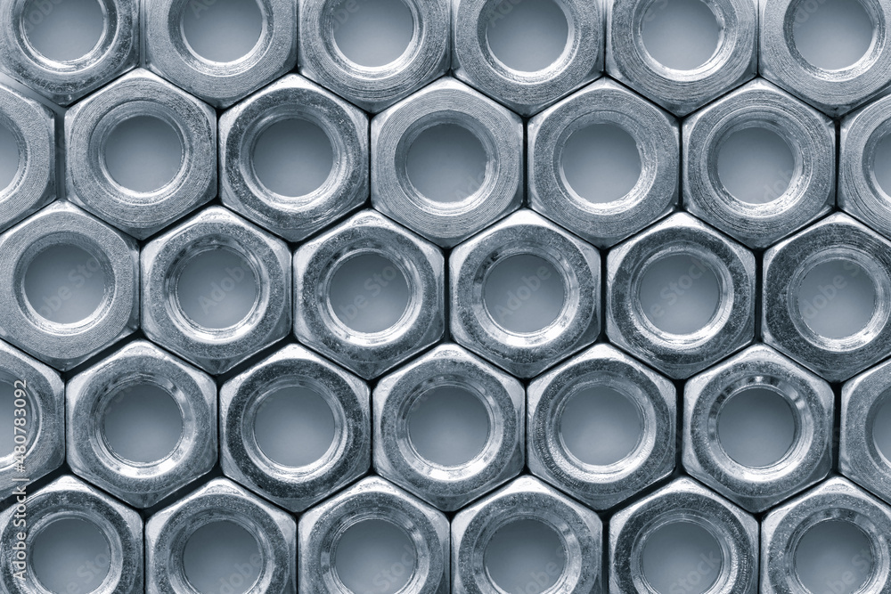 Poster Metal nuts in a row background. Chromed screw nuts. Steel nuts pattern. Tools for work.