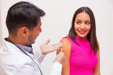 Doctor applying the vaccine against covid 19 and the new variant omicron
