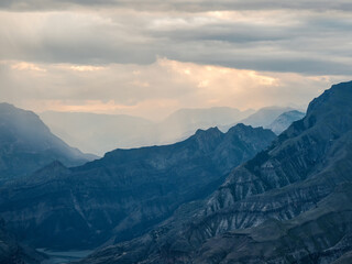 Dramatic sky on mountain peaks. Mystical background with dramatic mountains. Rain in mountains.