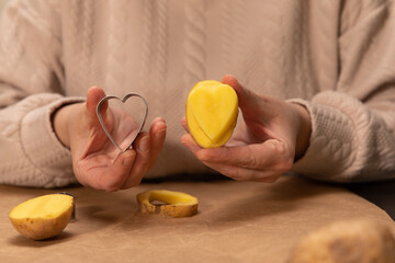 heart shaped potato stamp on craft paper. The process of decorating a gift for Valentine's Day. Getting ready for the celebration on February 14th.