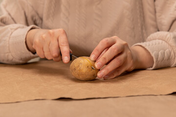 heart shaped potato stamp on craft paper. The process of decorating a gift for Valentine's Day. Getting ready for the celebration on February 14th.