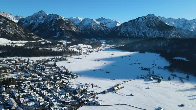 Aerial view of the snowy mountain village Oberstdorf with the mountain peaks in Bavarian Alps, Germany.
