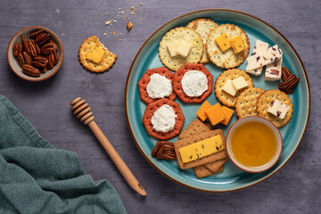 Food photography of cheese, cracker, nuts, honey