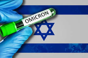 Israel outbreak of omicron variant. Hand holds a test tube with covid-19 virus omicron in front of...