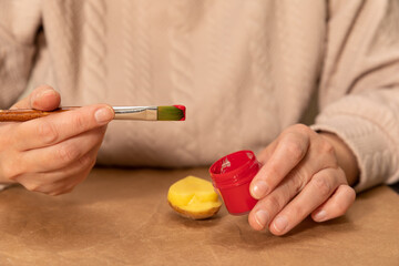 heart shaped potato stamp on craft paper. The process of decorating a gift for Valentine's Day. Getting ready for the celebration on February 14th.