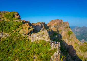 Aerial view of the mountains range in Madeira Island with a views balcony on a trail between Pico Ruivo and Pico Areeiro peaks