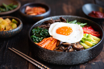  Bibimbap on a wooden background, traditional korean cuisine