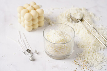 Tools and supply for candle-making: wicks, soy and coconut wax, gold foil, colors and aroma oils, bubble candle