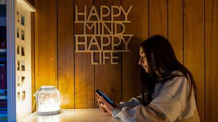 Young Adolescent GIrl focused reading an electronic book with her e-reader at evening. Happy mind,...