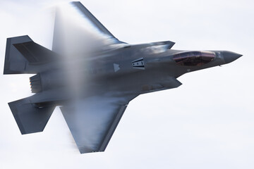 Very unusual close view of a F-35C  in a high G maneuver , with condensation clouds over the wings...